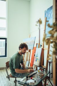 Rafael Martig zit in gedachten in zijn lichte atelier, met een penseel in zijn hand. Hij neemt verf op van een glazen palet vol kleuren en materialen. Het daglicht stroomt de ruimte binnen en laat de schilderijen, schildersezels en werkmaterialen om hem heen mooi uitkomen.